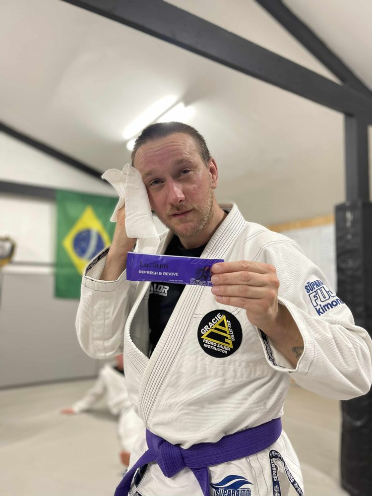Athlete using Luxium Sport towel after martial arts training